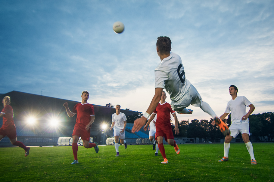 a group of men playing soccer outdoors